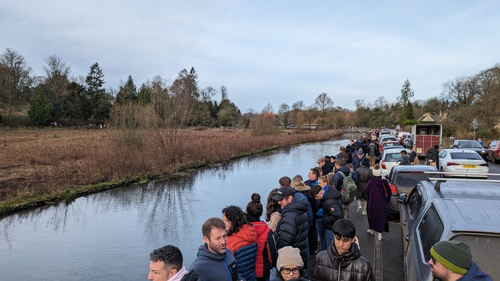 People standing beside river