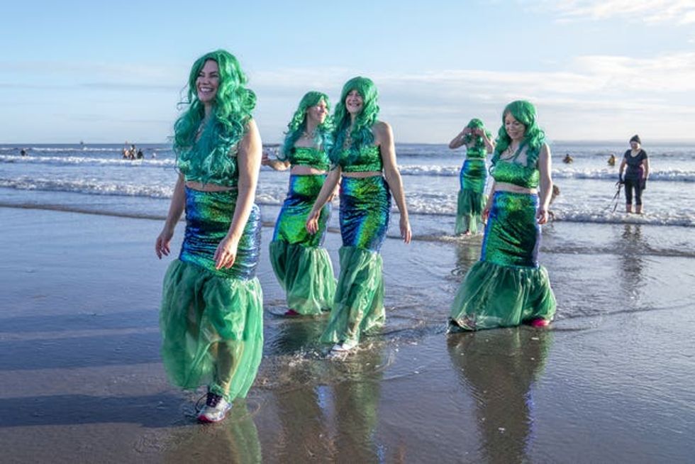 People take part in a Loony Dook New Year\u2019s Day dip in the Firth of Forth at Kinghorn in Fife