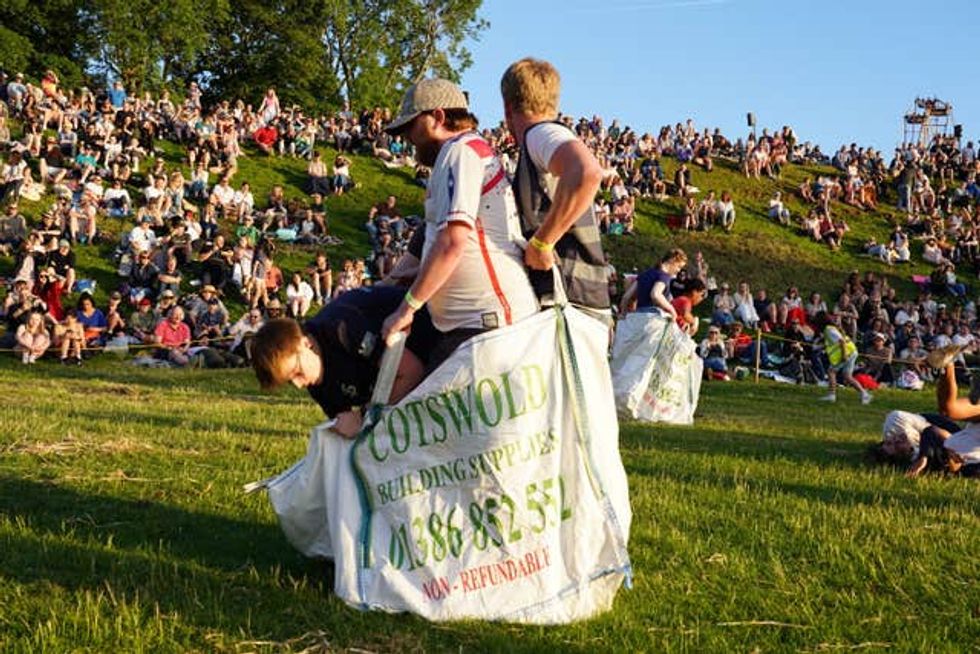 People take part in a team sack races