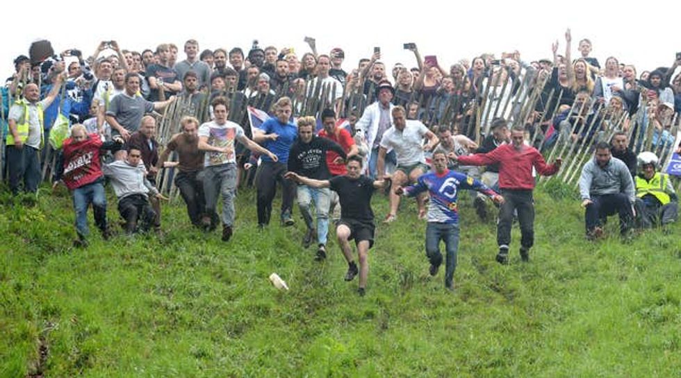 People taking part in a cheese rolling race