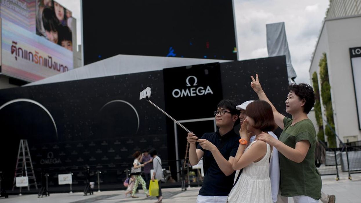 People using selfie sticks in Bangkok