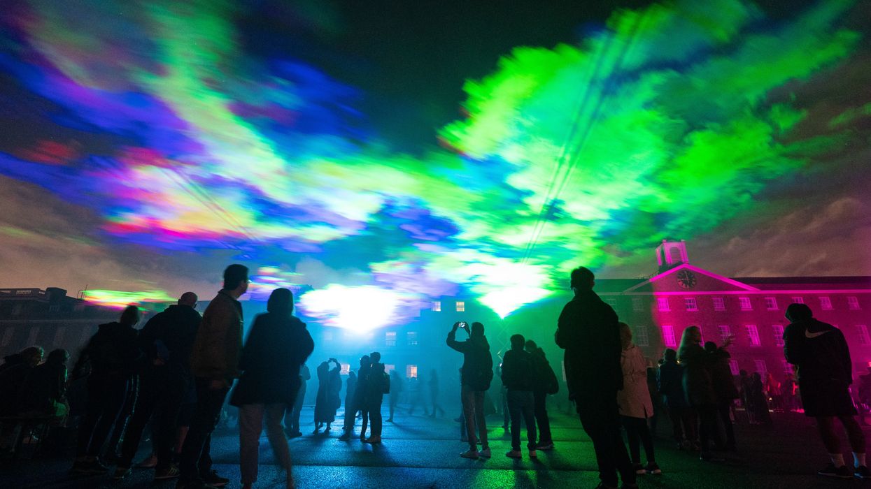 People view ‘Borealis’ a laser light art installation by Dan Acher (Dominic Lipinski/PA)