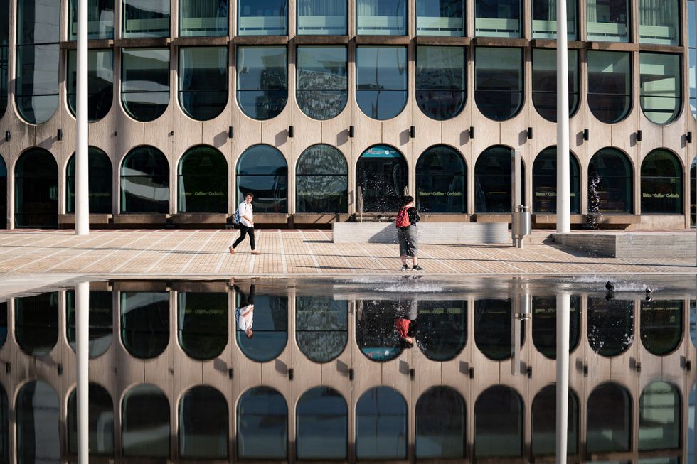 People walk by Centenary Square in Birmingham