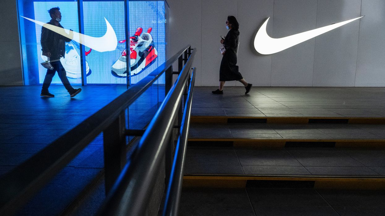 People walk outside a Nike store at a shopping area on April 8, 2021 in Beijing, China