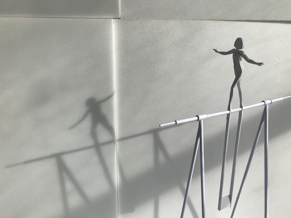 Person walking on tightrope