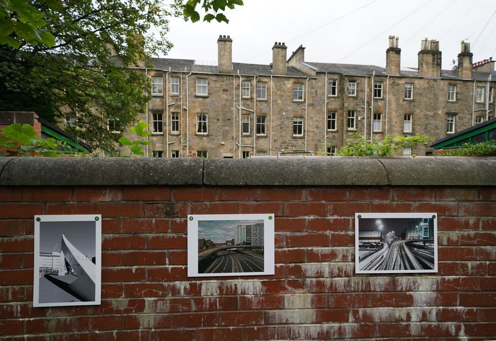 Photographs attached to a wall as part of the exhibition (Andrew Milligan/PA)