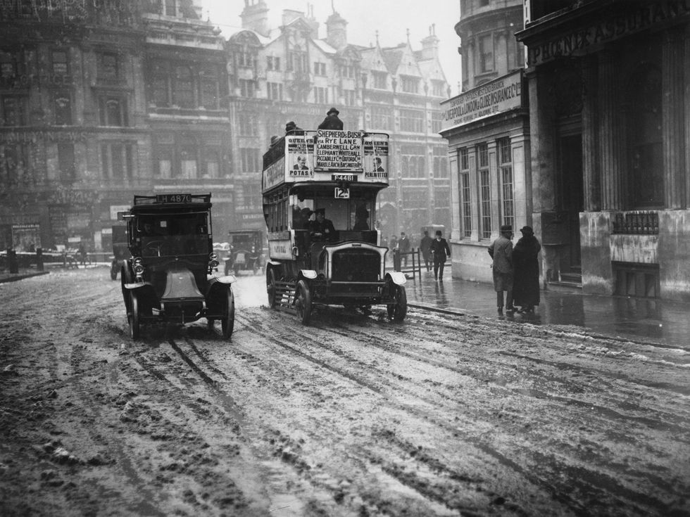 Picture: A taxi and a bus in the snow at Trafalgar Square in London