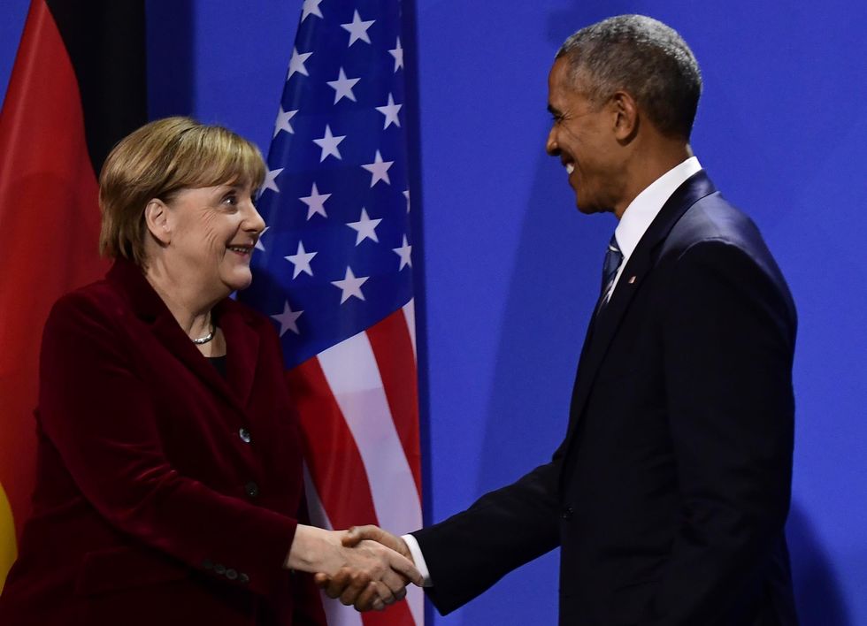 Picture: Barack Obama and German Chancellor Angela Merkel shake hands after addressing a press conference after their meeting at the chancellery in Berlin on November 17, 2016/