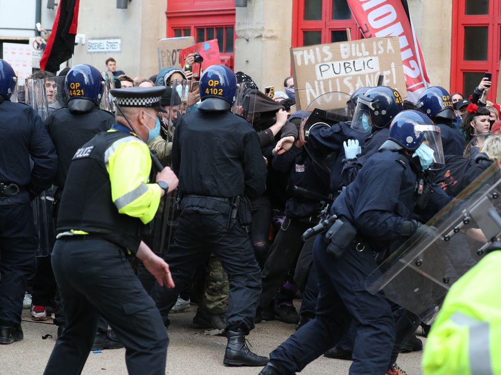 Police hold back people outside Bridewell Police Station as they take part in a 'Kill the Bill' protest in Bristol