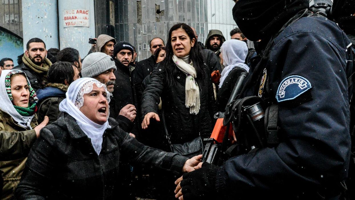 Police officers stand guard on December 31, 2015 in Diyarbakir, Turkey