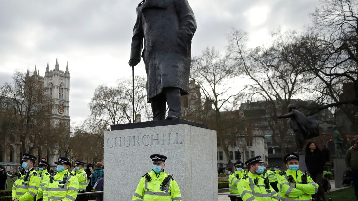 Police stand guard around the statue of wartime prime minister Winston Churchill in Parliament Square