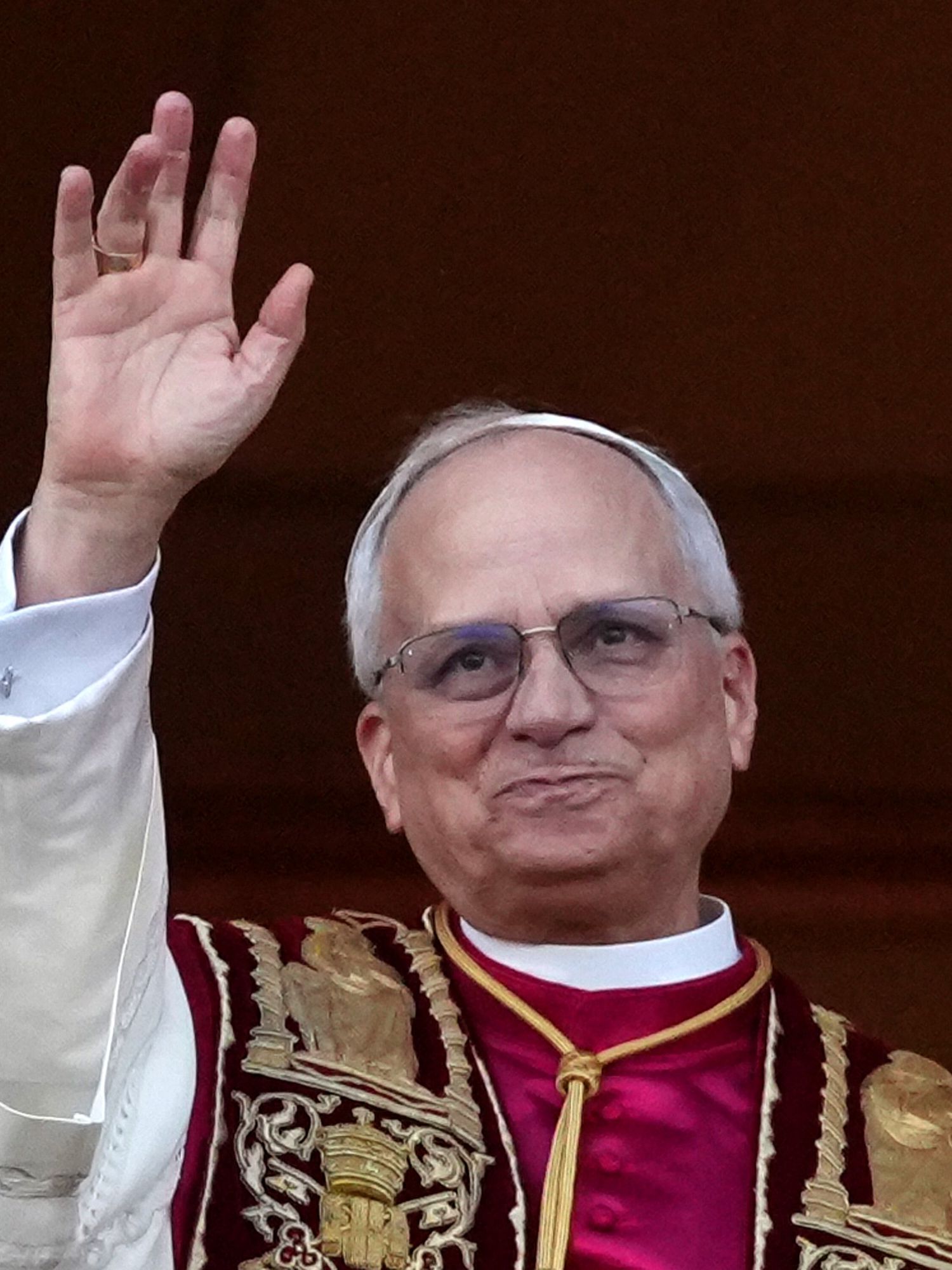 Pope Francis waving to crowds from the Vatican balcony.
