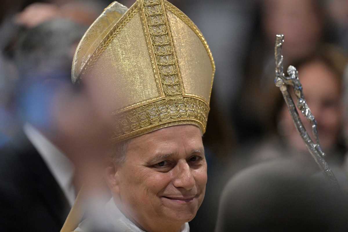 Pope Leo smiling and wearing a golden skullcap.