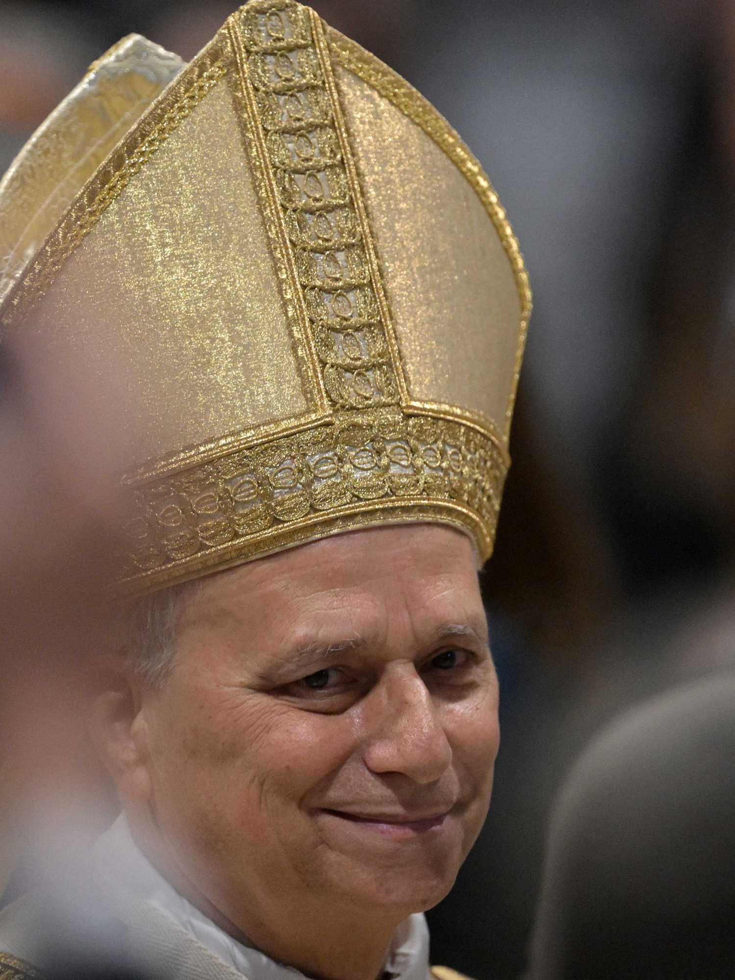 Pope Leo smiling and wearing a golden skullcap.