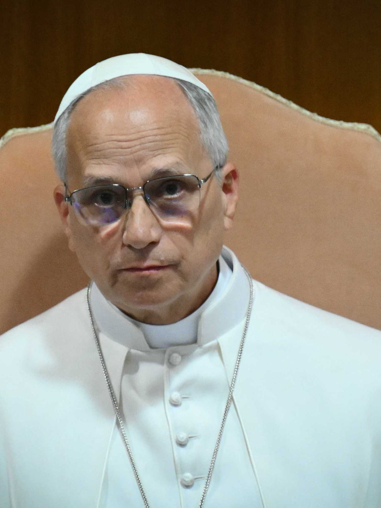 Pope Leo XIV, in his white religious clothing, sitting in a cream chair.