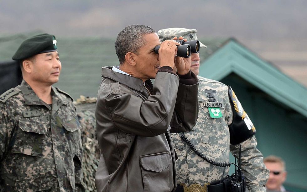 President Barack Obama uses binoculars to look at North Korea from the Demilitarized Zone which separates the two Koreas, Panmunjom, 2012
