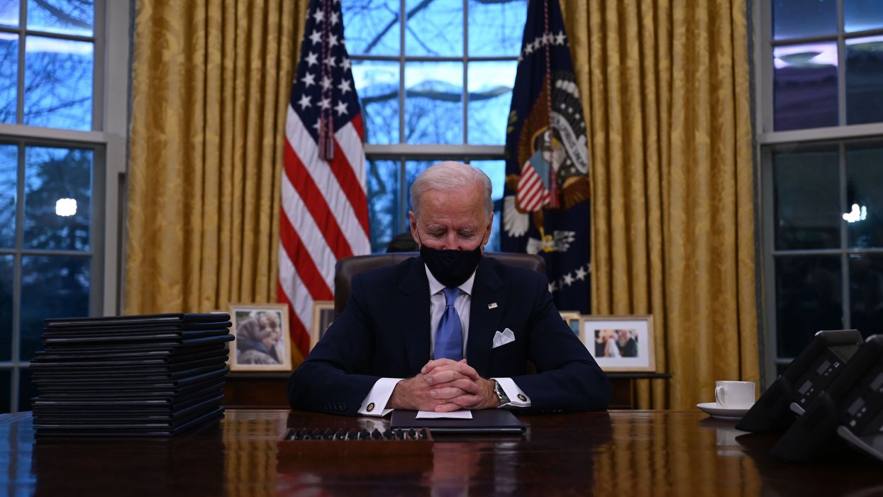 President Joe Biden sits in the Oval Office at the White House 