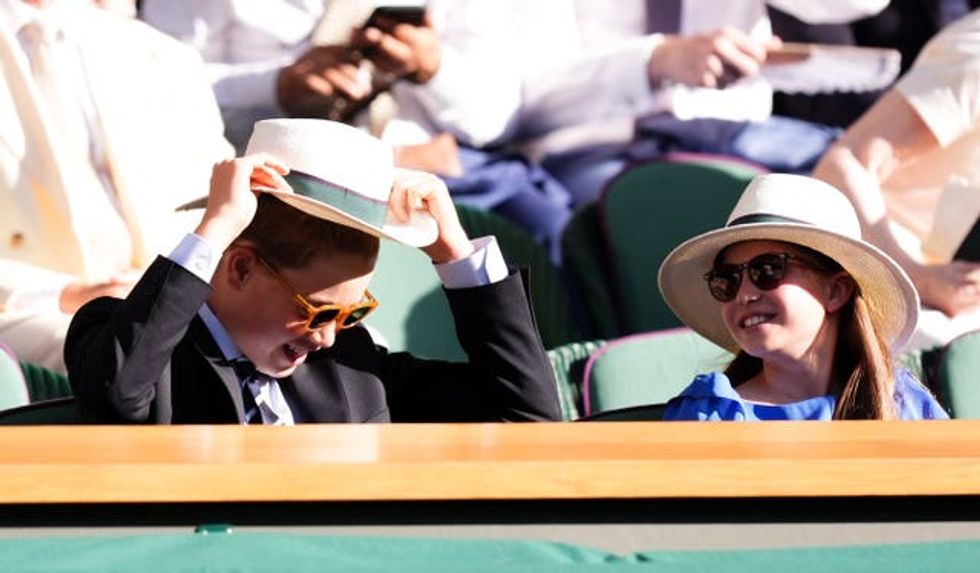 Prince George and Princess Charlotte wearing hats and sunglasses in the royal box at Wimbledon