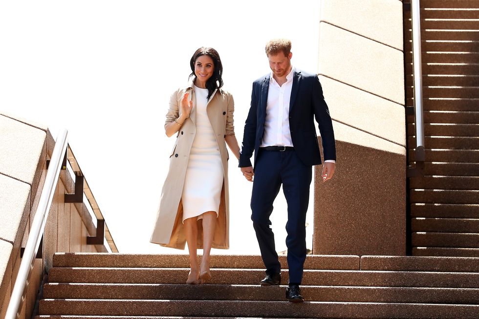 Prince Harry, Duke of Sussex (R) and Meghan, Duchess of Sussex (L) arrive at the Sydney Opera House on October 16, 2018