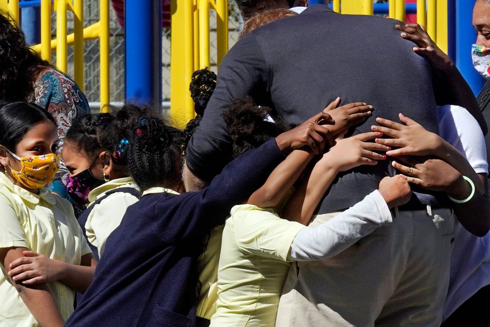 Prince Harry was given a group hug (Richard Drew/AP)