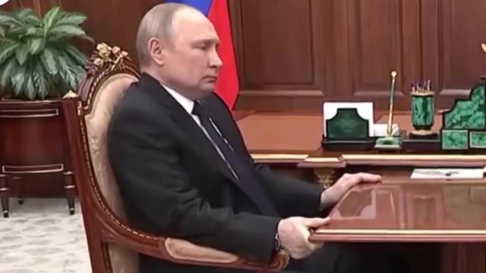 Vladimir Putin gripping table meeting Sergei Shoigu 2022