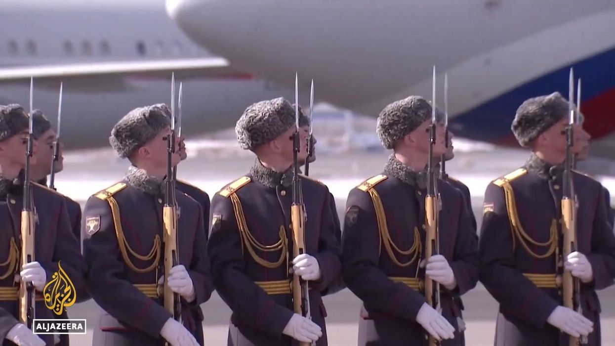 Why do Russian guards tilt their head and watch when leaders walk past?