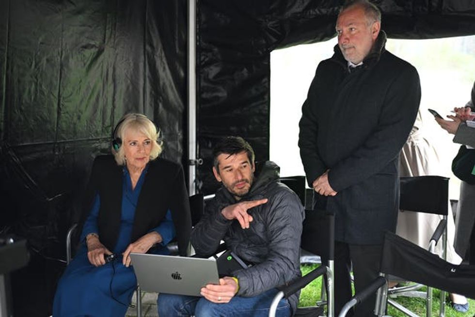 Queen Camilla with VFX supervisor Mark Robinson and executive producer Jed Mercurio (right) during a visit to the set of ITV drama Trigger Point in north London