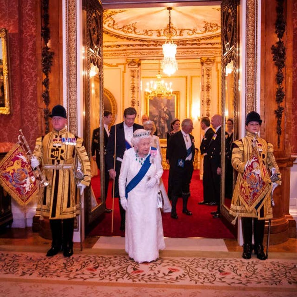 Queen Elizabeth II entering the room years later at the annual evening reception for Members of the Diplomatic Corps at Buckingham Palace in 2019