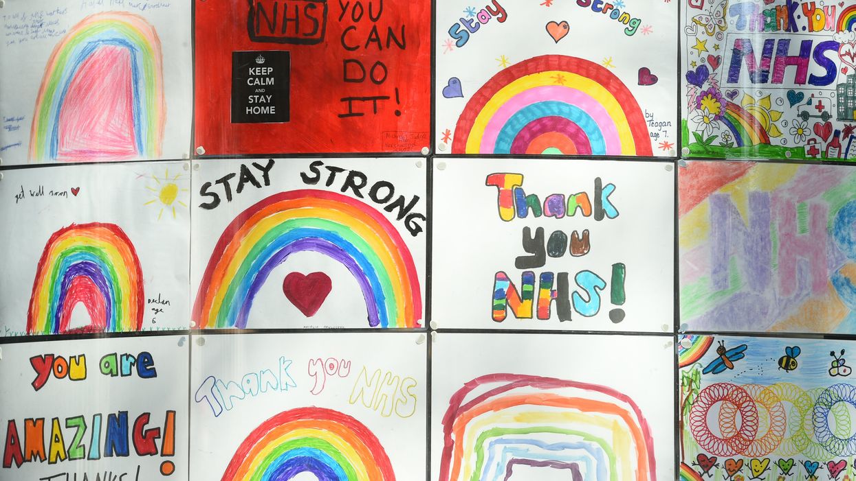 Rainbow signs painted by students in the window of the DLD College across the road from St Thomas’ Hospital in Central London (Kirsty O'Connor/PA)