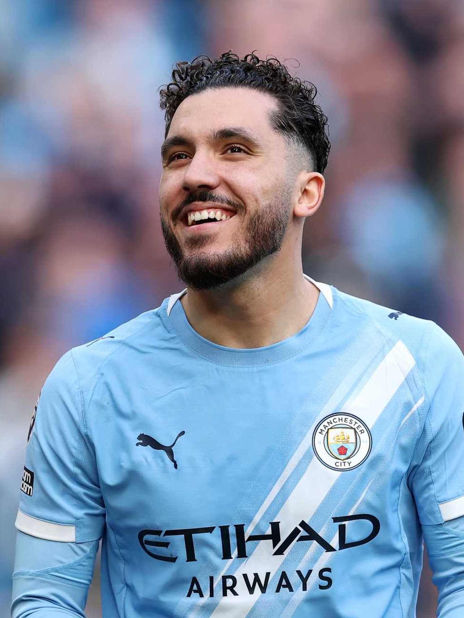 Rayan Cherki of Manchester City smiles following victory in the Premier League match between Manchester City and Arsenal at Etihad Stadium on April 19, 2026 in Manchester, England