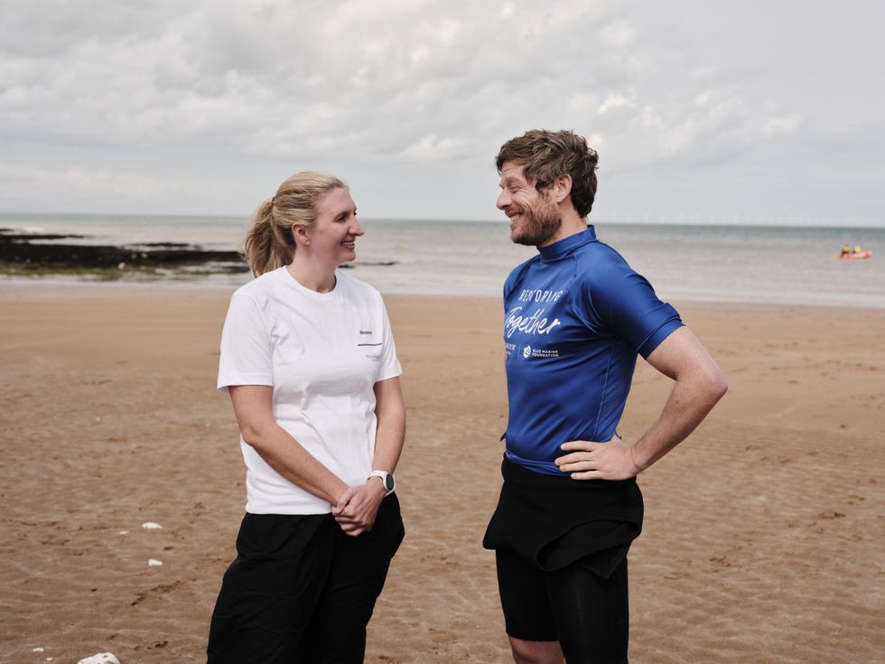 Rebecca Adlington and James Norton on a beach