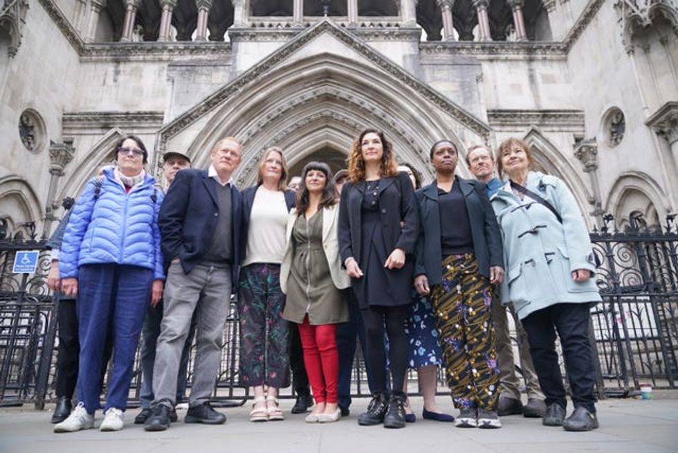 Rebekah Shaman (front centre), from the Protect Brockwell Park group, stands with other residents from Brockwell outside the Royal Courts of Justice in London
