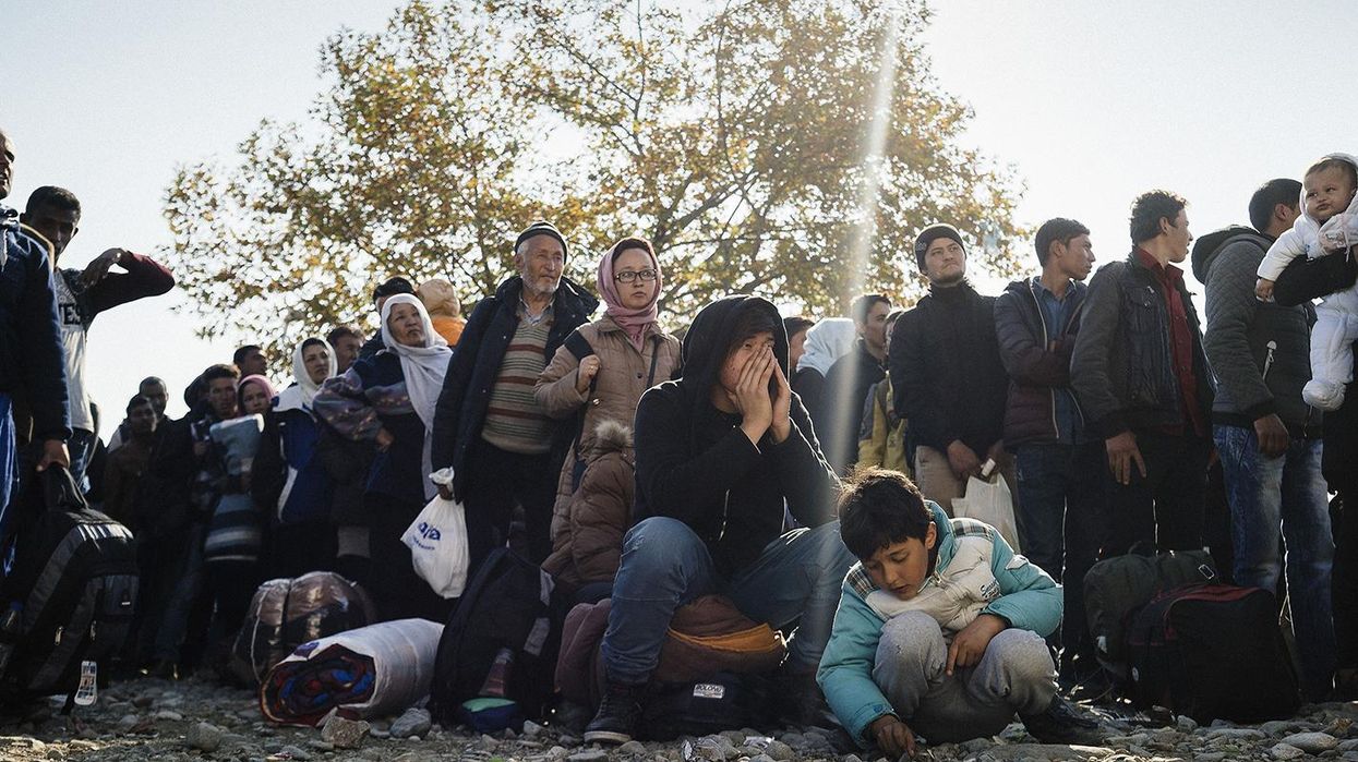 Refugees wait to enter a registration camp after crossing the Greek-Macedonian border