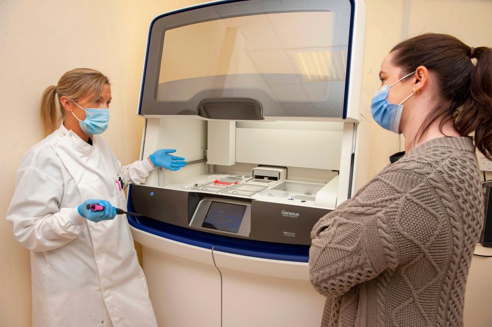 Reiltin Werner, Chief Medical Scientist, Histopathology at CUH, demonstrating how the new Ion Torrent Sequencer works, to Claire Concannon of the CUH Charity. (Colm Lougheed/PA)