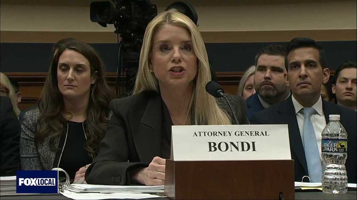 Trump banner erected outside DOJ slammed as ‘shameful’ and ‘beyond parody’