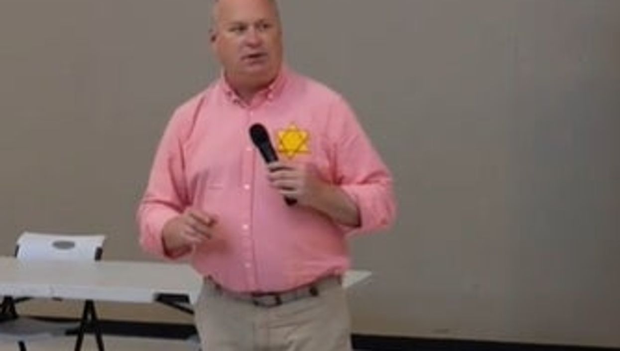 <p>Rep. Jim Walsh during his speech can be seen wearing a yellow Star of David at the protest</p>