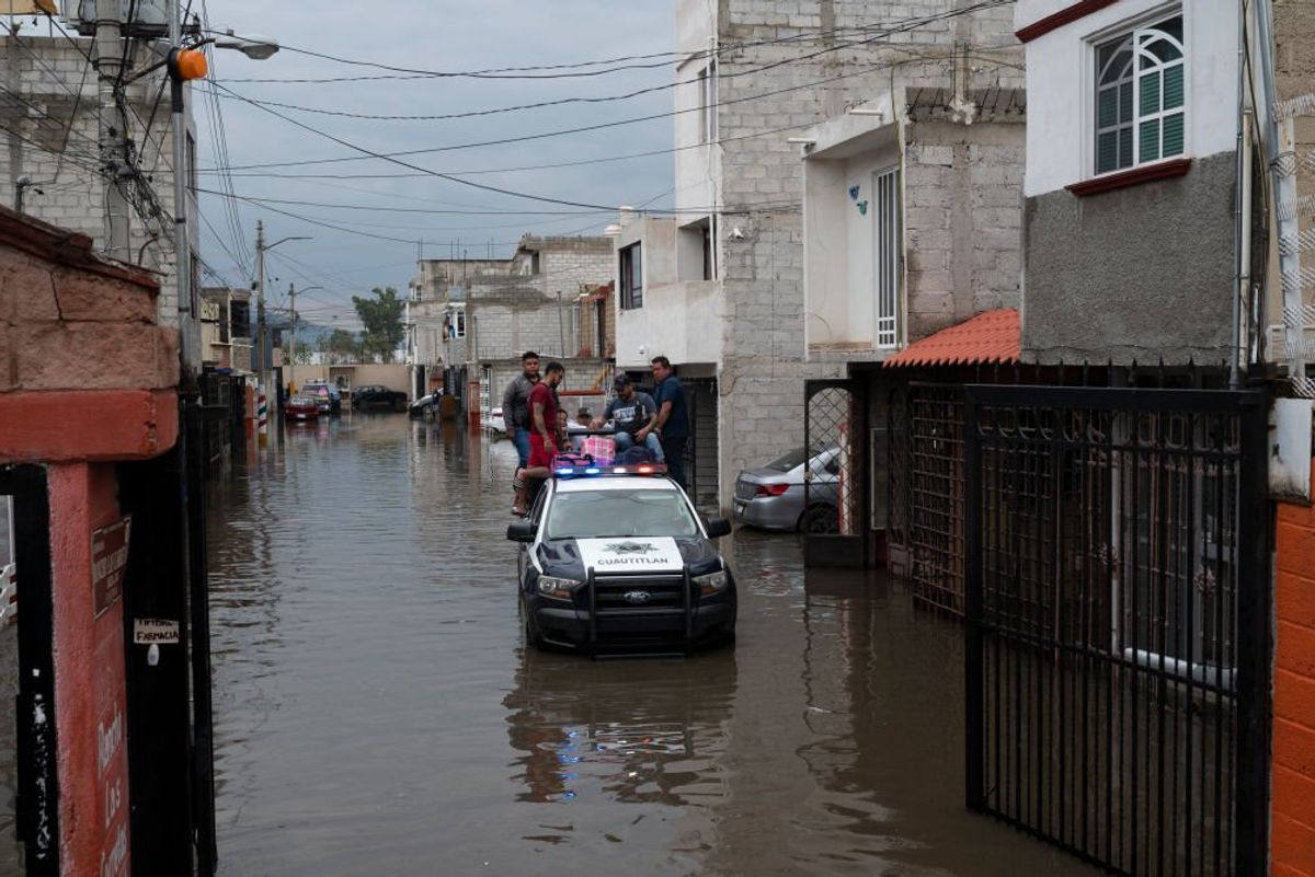 Residents flee the flooded Rancho San Blas neighborhood in Cuautitlan, Mexico, on June 28, 2024