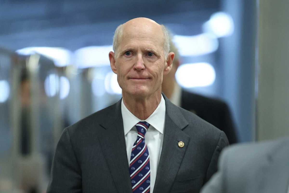 Rick Scott, a white man in a black suit.