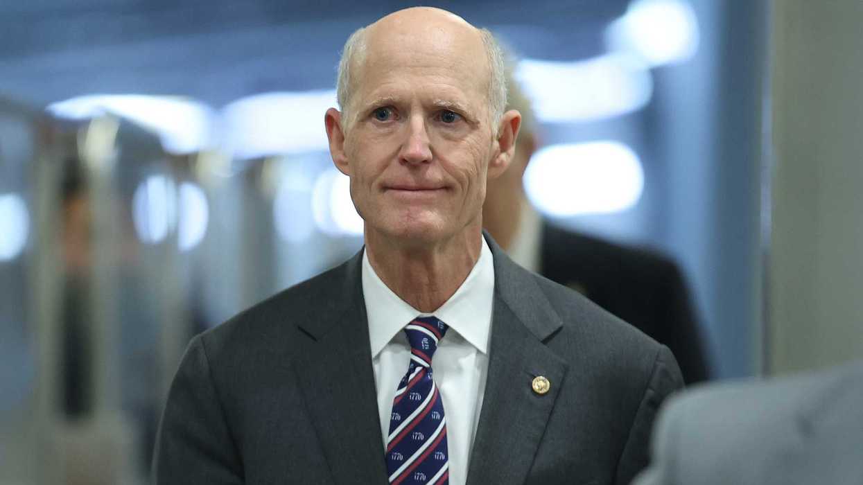 Rick Scott, a white man in a black suit.