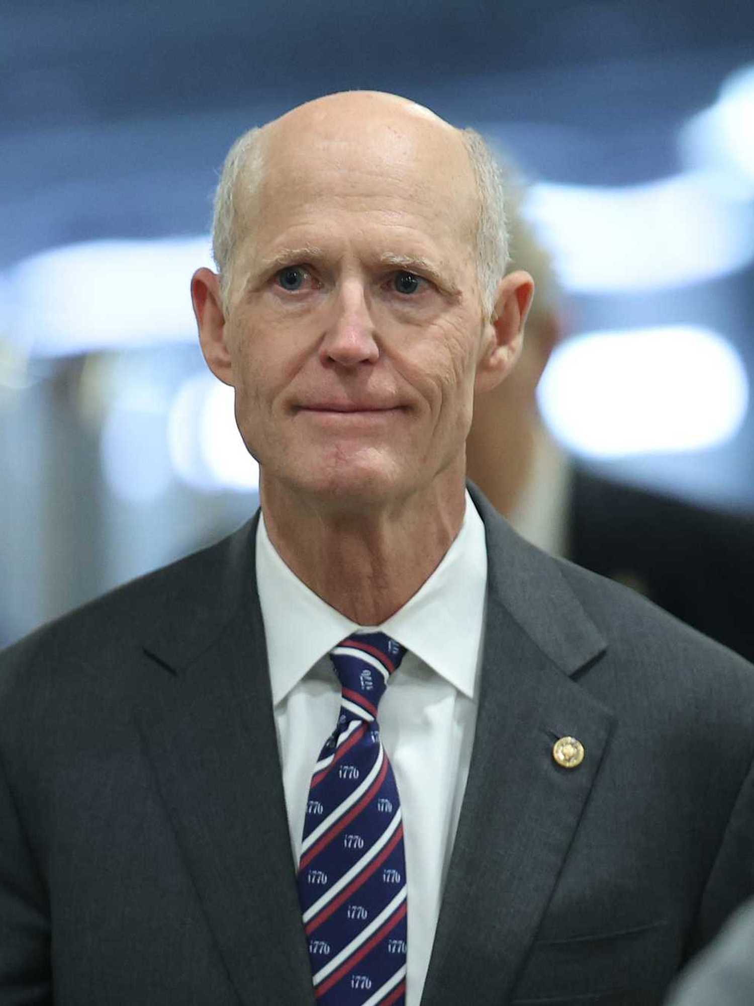 Rick Scott, a white man in a black suit.