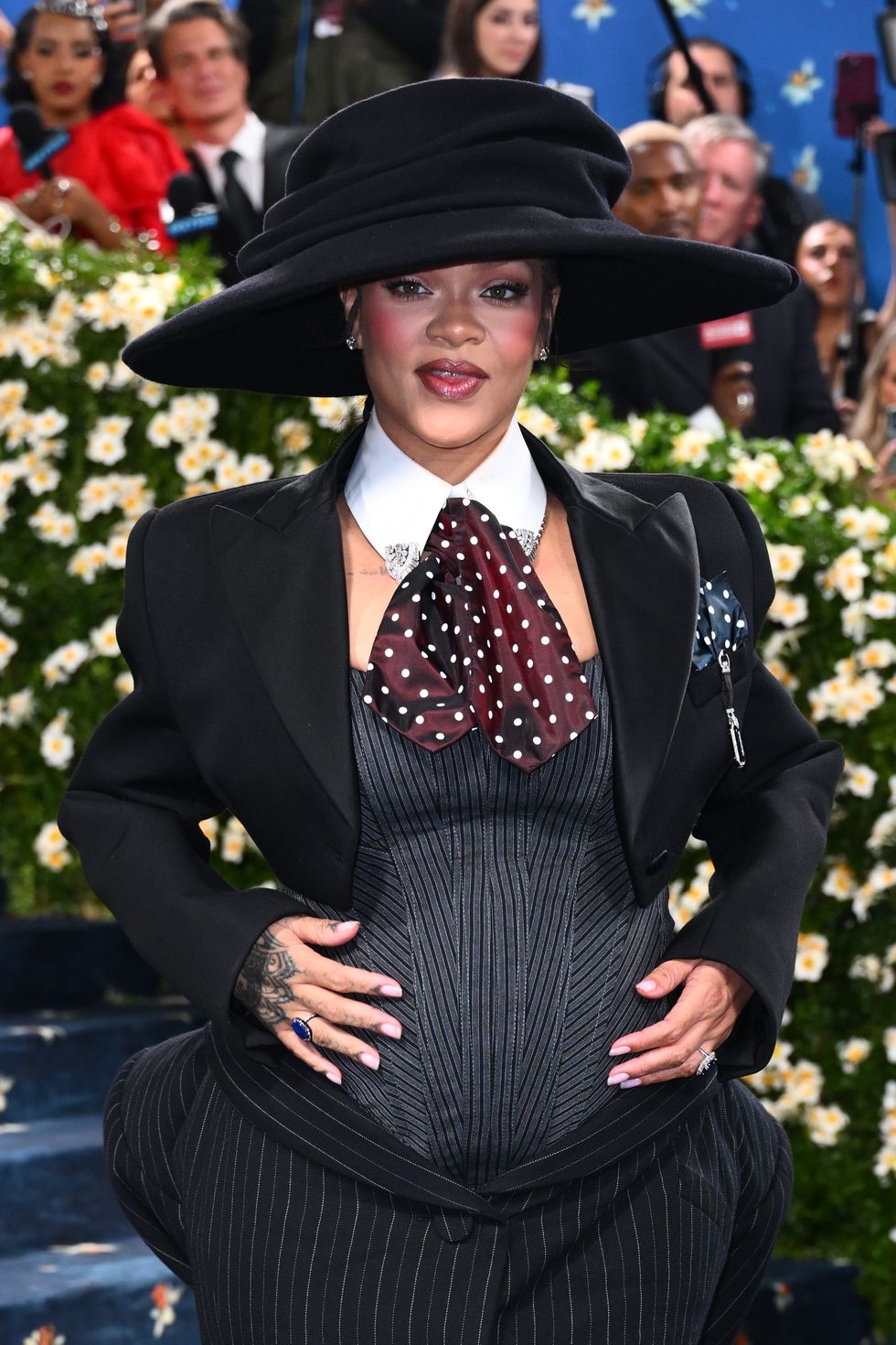 Rihanna debuts baby bump on star-studded Met Gala blue carpet