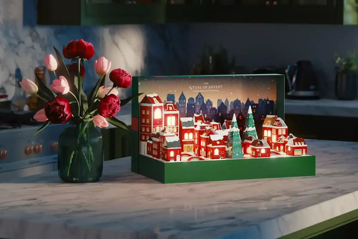 Rituals' advent calendar is green with a Christmas town scene representing each of the boxes.