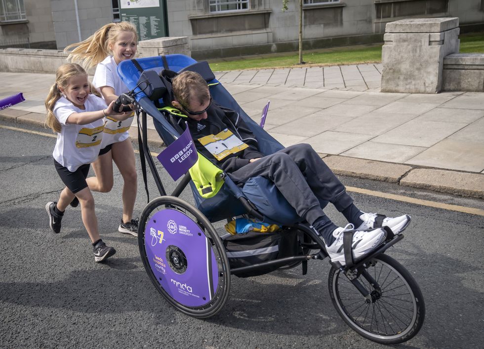 Rob Burrow pushed around Leeds fun run course by daughters on Father’s Day