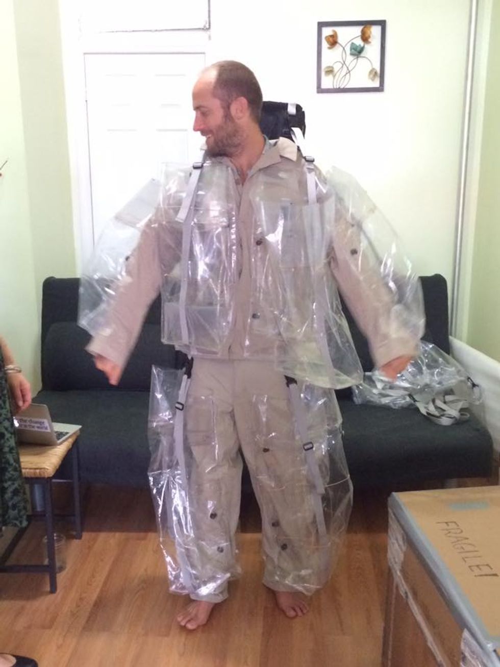 Rob Greenfield tries on his Trash Me suit, made by Recycle Runway's Nancy Judd, for the first time