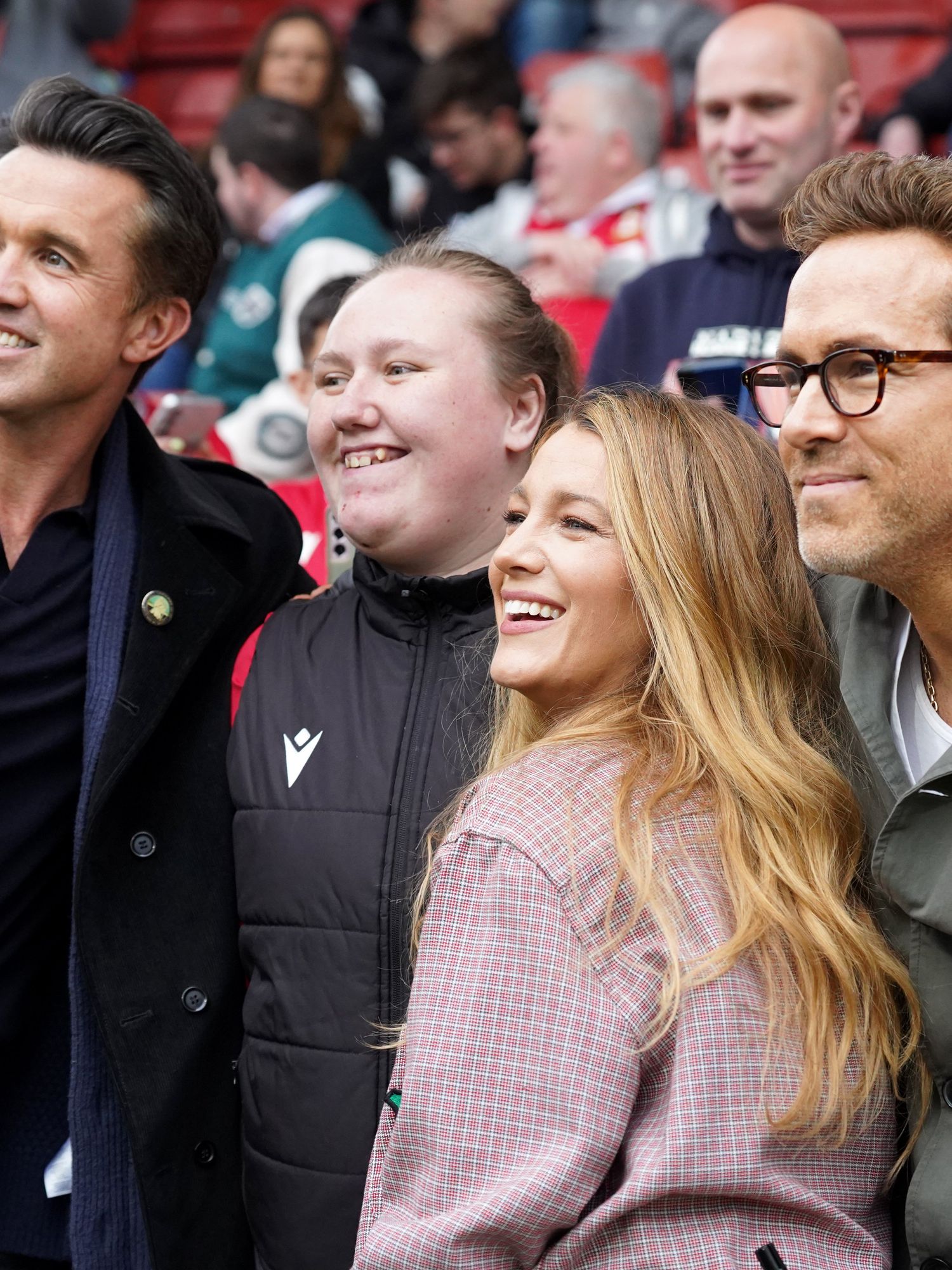 Rob McElhenney, Ryan Reynolds ,co-owners of Wrexham AFC, and Blake Lively pose for a photo during the Sky Bet League One match between Wrexham AFC and Charlton Athletic FC at Racecourse Ground on April 26, 2025 in Wrexham, Wales
