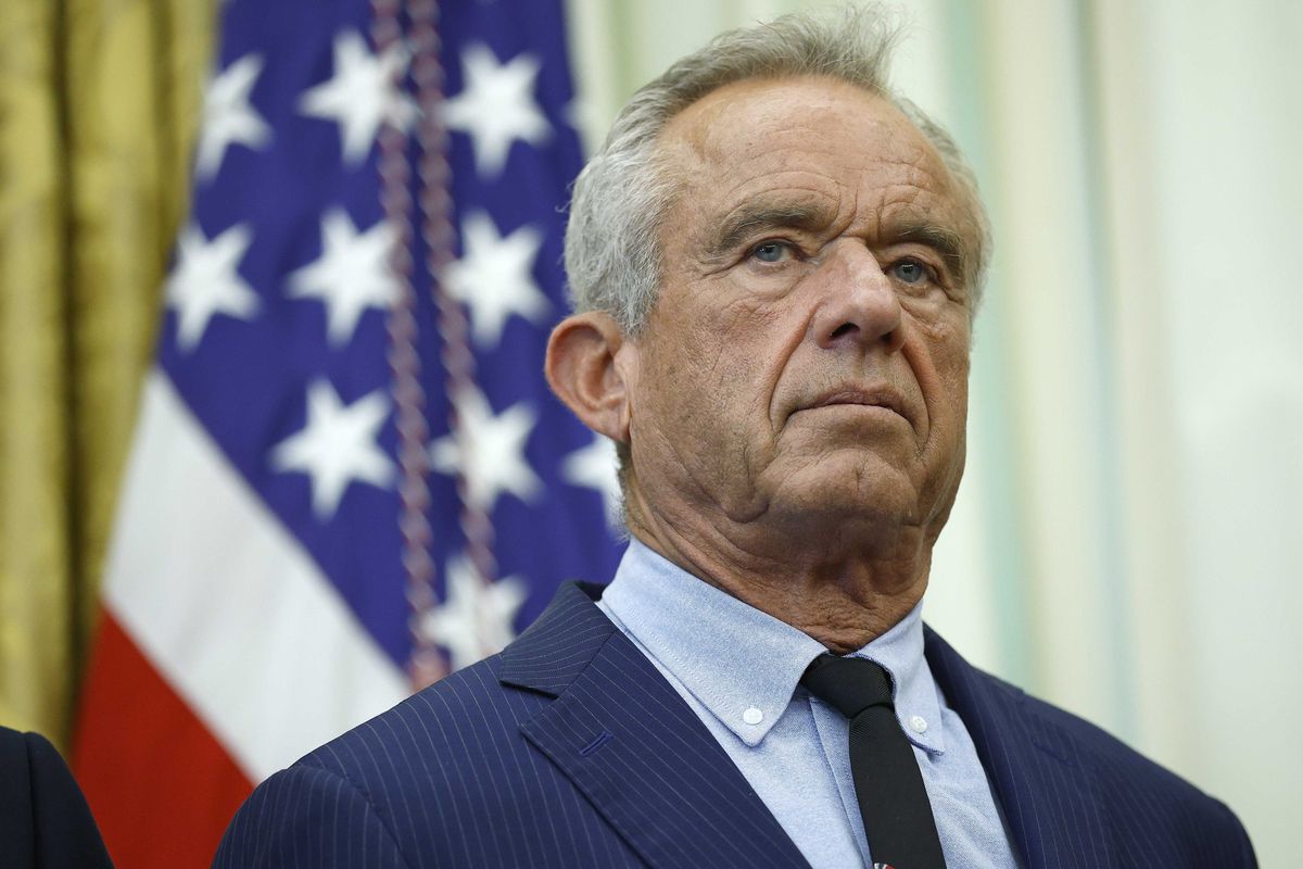 Robert F Kennedy Jr, a white man with short grey hair and a blue suit, in the Oval Office.