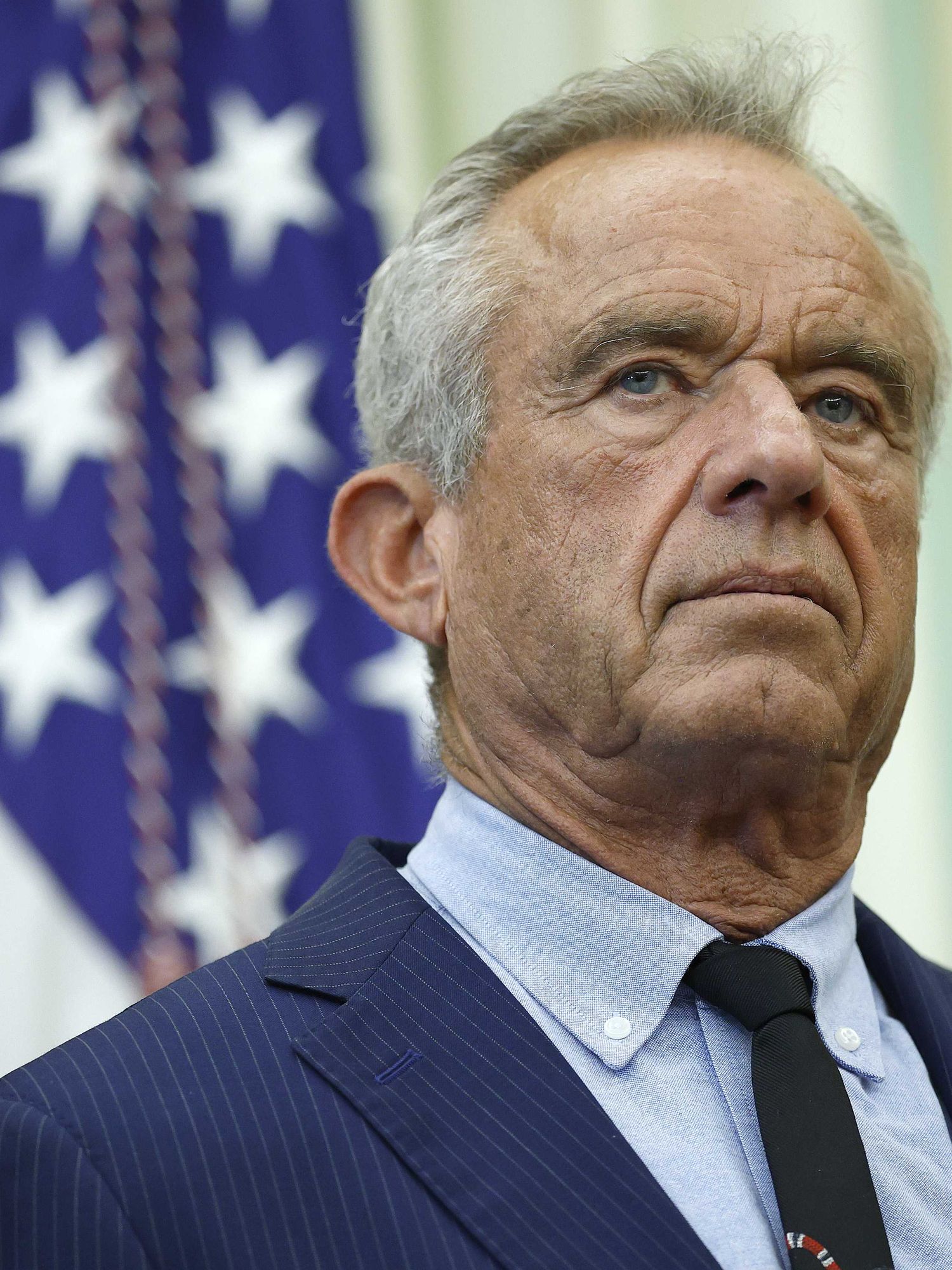 Robert F Kennedy Jr, a white man with short grey hair and a blue suit, in the Oval Office.