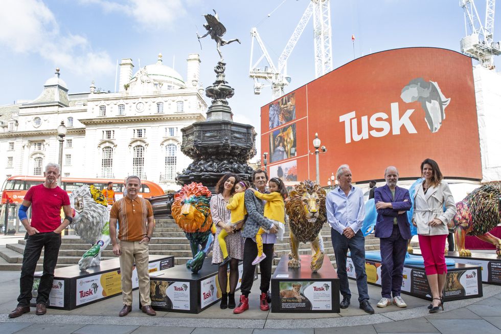 Rolling Stones guitarist Ronnie Wood and his wife Sally with daughters Gracie and Alice, alongside artists Gavin Turk, David Mach and Hannah Shergold during the launch of the Tusk Lion trail at Piccadilly Circus in London (Joshua Bratt/PA)