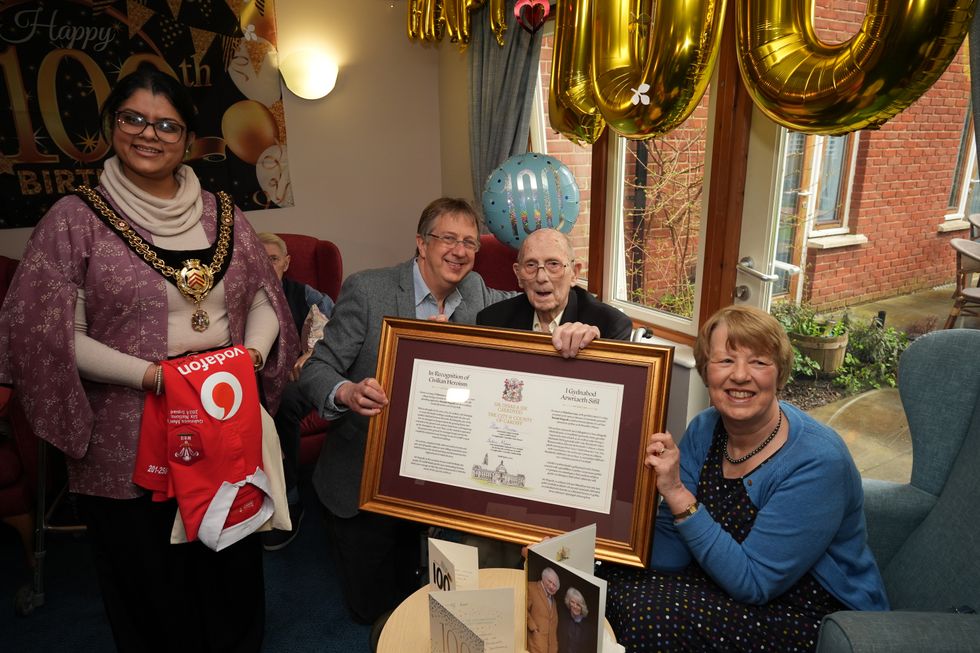 Wartime hero who saved famed building grins as he is honoured on 100th birthday