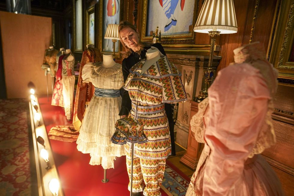 Royal Collection Trust curator Caroline de Guitaut puts the finishing touches to The Princesses\u2019 Pantomimes costume display at Windsor Castle (Steve Parsons/PA)